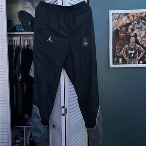 Jordan Joggers, color black with yellow detailing, it is a size small.